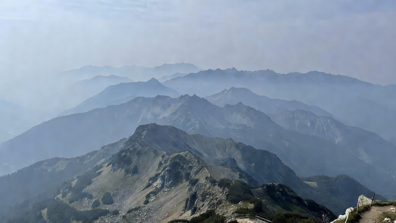 Layered mountain ridges fading into cool haze from a high public viewpoint